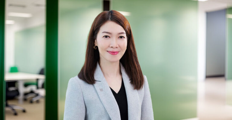 Profile photo of Carrie Tong with blurred office background.