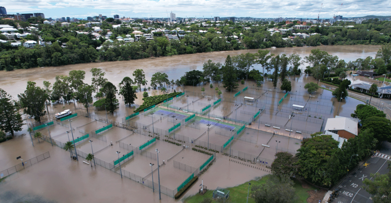 Flooded tennis courts and building in St Lucia, Queensland during 2022 floods.