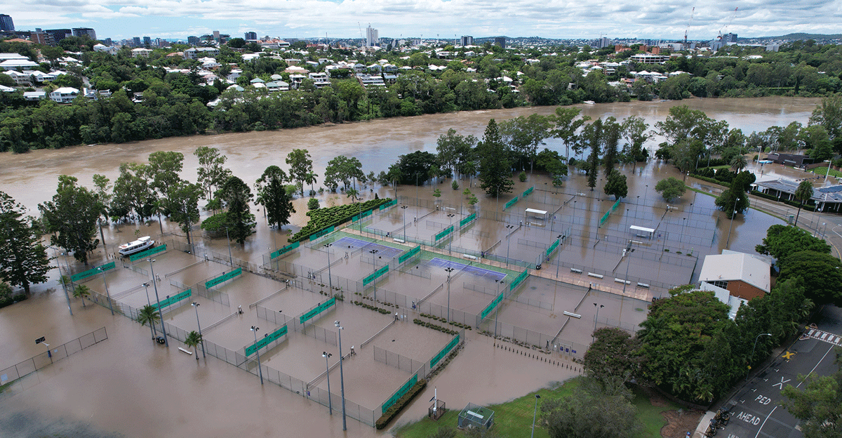 Flooded tennis courts and building in St Lucia, Queensland during 2022 floods.