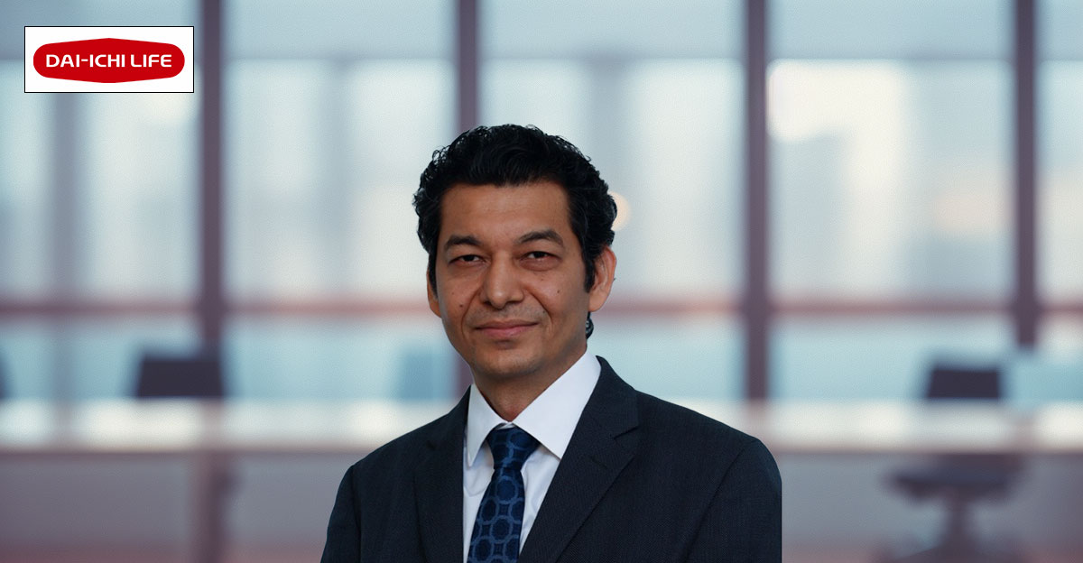 Profile photo of Sanjay Karnatak with blurred office background.