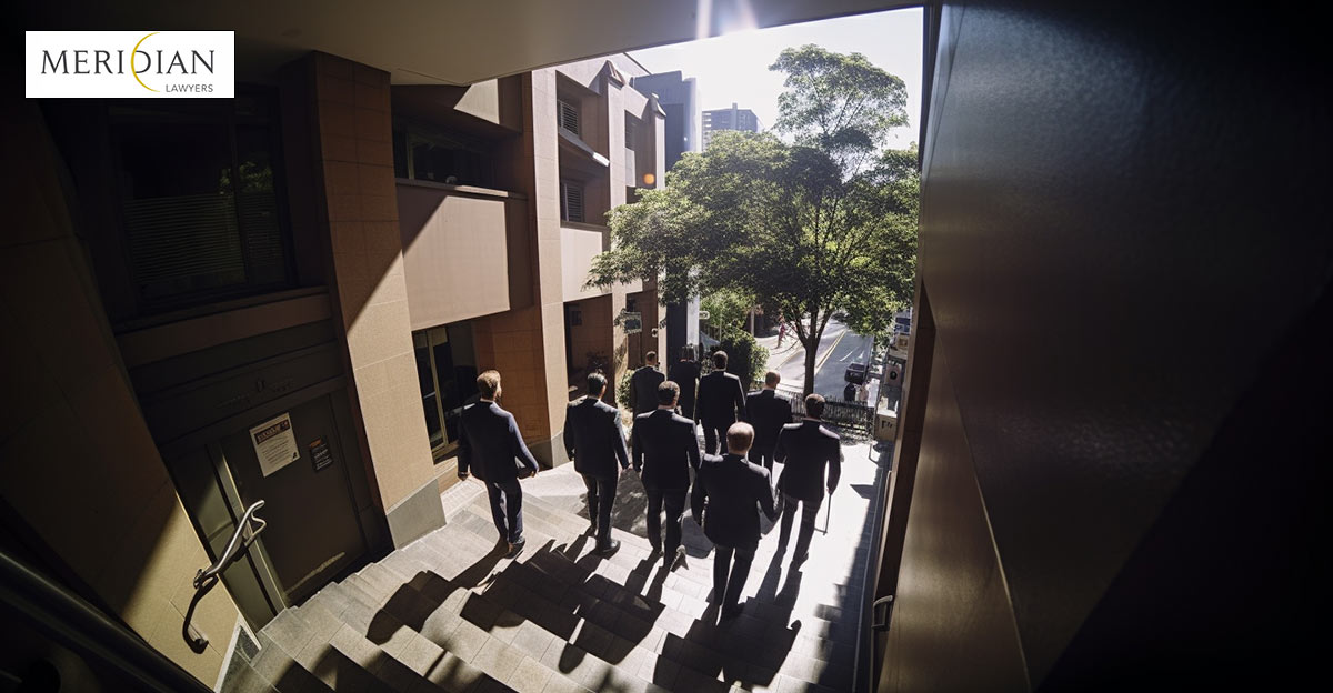 Photo of a group of lawyers walking down stairs. Meridan logo in top left.