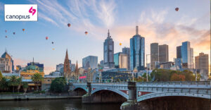 Photo of Melbourne with hot air balloons in the sky. Canopius logo in top left corner.