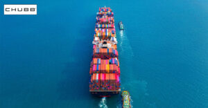 Beautiful photo of marine cargo ship on the ocean. Chubb logo in top left corner.