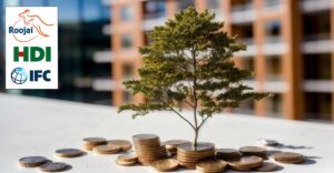 Photo of plant growing out of coins with blurred buildings in background. Roojai, HDI and IFC logos in top left corner.