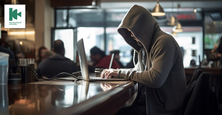 Photo of person wearing hoodie in cafe. Insurance Council of Australia logo on top left corner.