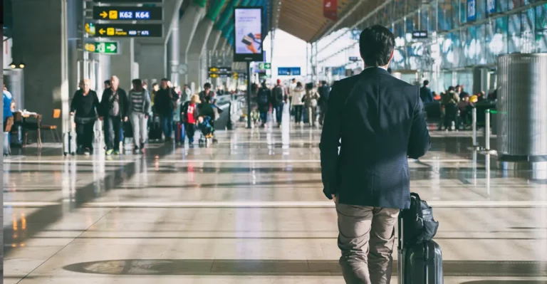 Photo of man walking in airport.