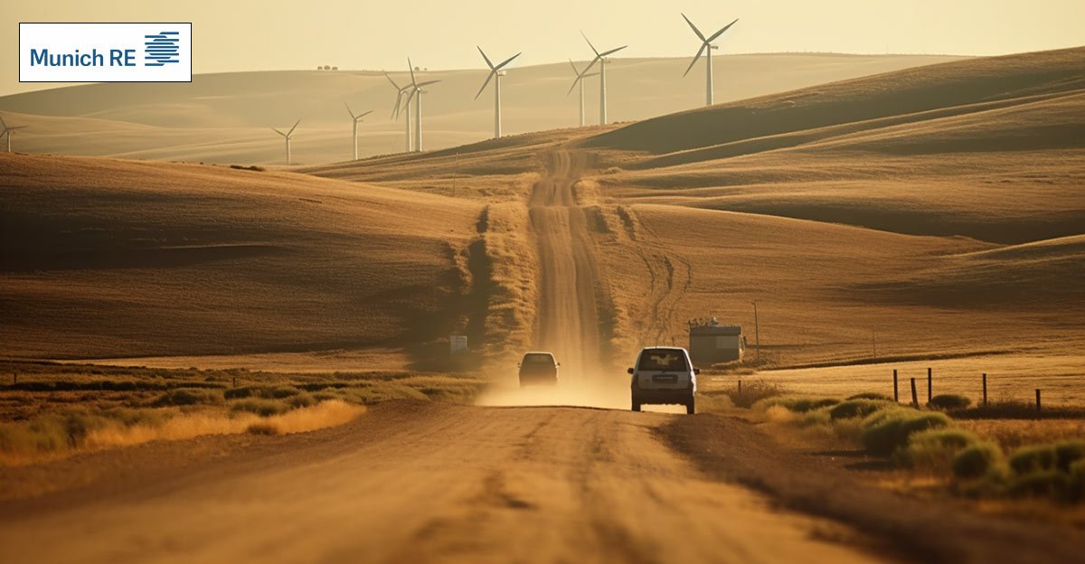 Photo of cars on a dirt road with windmills in the background. Munich Re logo in top left.