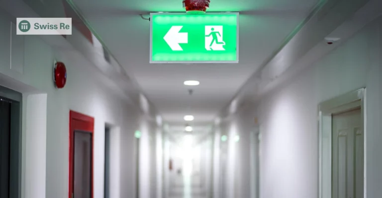 A photo of an exit sign. Swiss Re logo in top left corner.