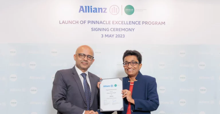 A photo of two people holding a certificate of signing.