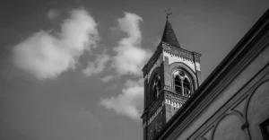 A black and white photo of a church steeple.