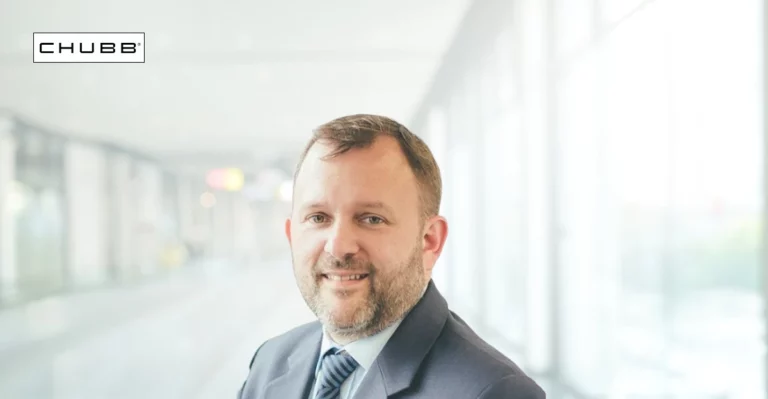 A profile photo of Mark Homan with blurred office background. Chubb logo in top left corner.