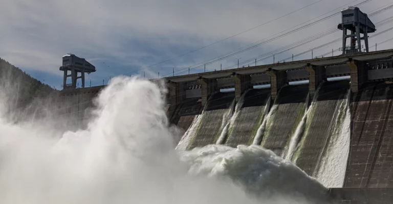 A photo of a hydropower with water rushing out in a flood.