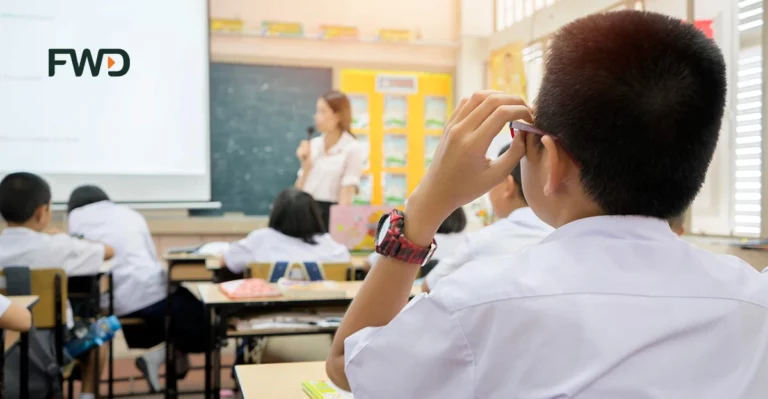 A photo of Children in classroom. FWD logo in top left corner.