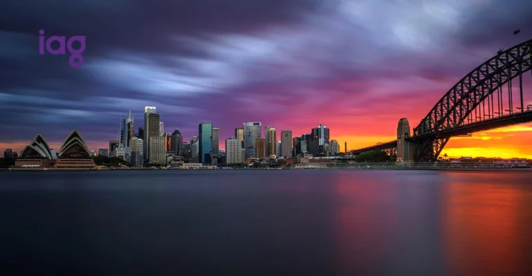 A photo of Sydney Harbour at sunset. IAG logo in top left corner.