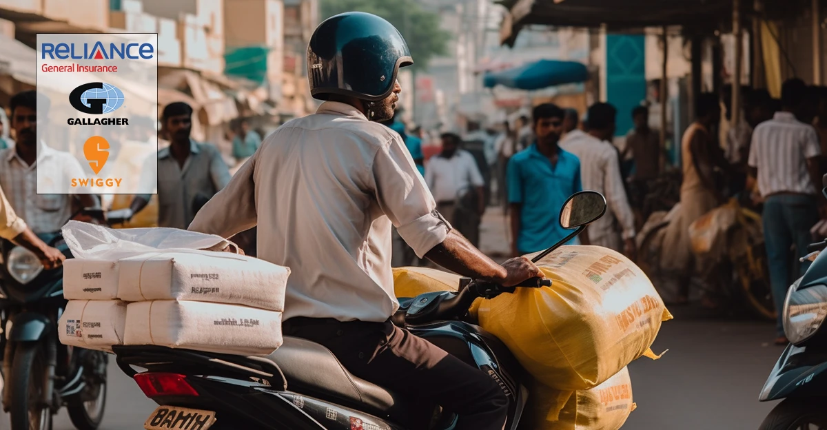 A photo of Food delivery drive on on motorbike in India. Reliance, Gallagher, and Swiggy logo in top left corner.