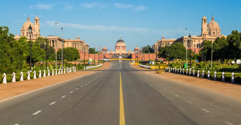 An empty road leading to a building.