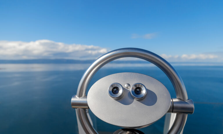 A pair of binoculars looking out over the ocean.