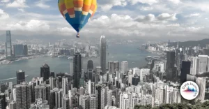 A hot air balloon flying over a city.