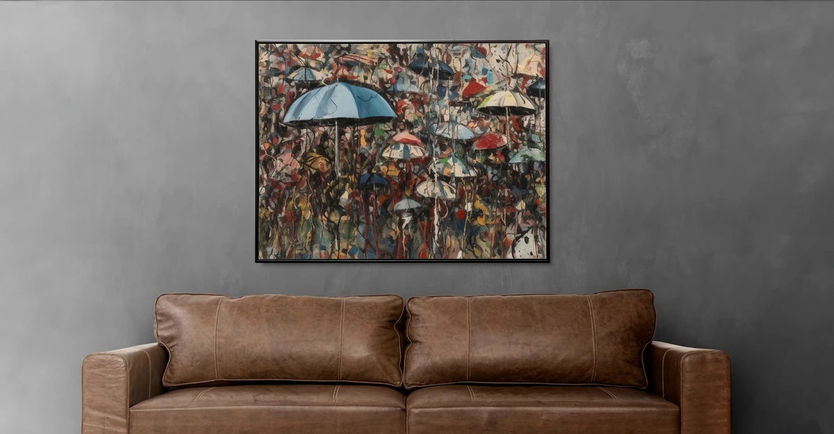 An abstract painting of umbrellas hanging above a leather couch.