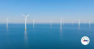 A group of wind turbines in the ocean.