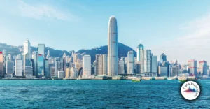 The skyline of hong kong is seen from the water.