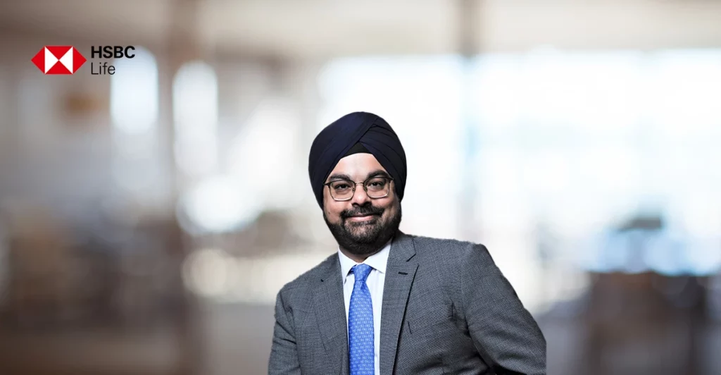 A man in a suit and turban is posing for a photo.