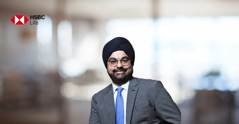 A man in a suit and turban is posing for a photo.