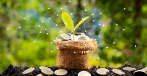 A plant is growing out of a sack of coins.