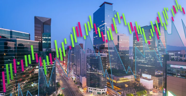 An image of a stock chart with a city in the background.