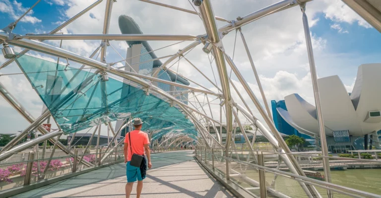 A man walking on a bridge in singapore.