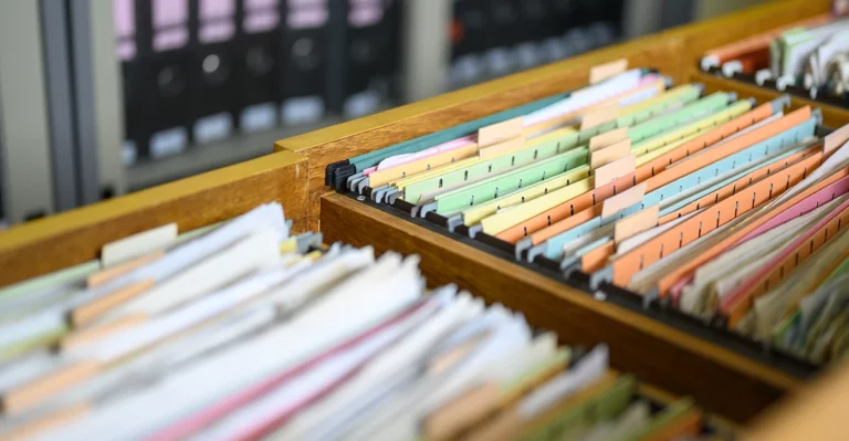 A drawer full of papers in a filing cabinet.