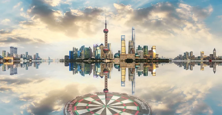 The city of shanghai is reflected in the water.