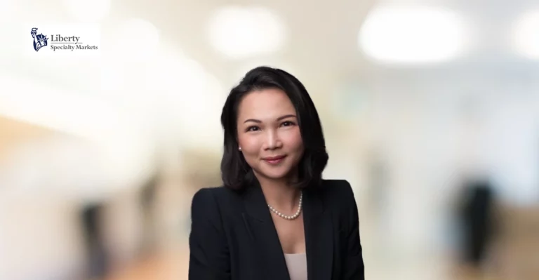 A woman in a business suit posing for a photo.