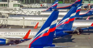 A group of airplanes parked at an airport.