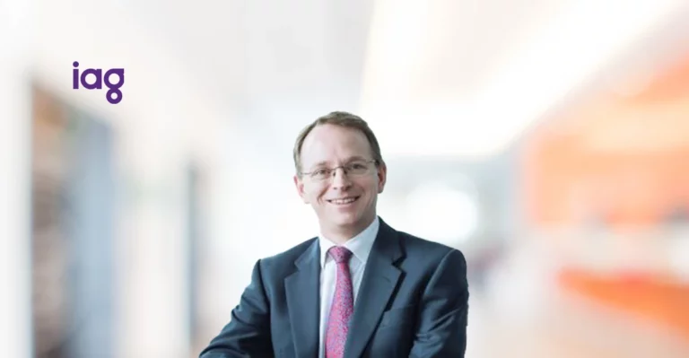 A man in a suit and tie sitting in an office.