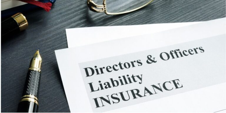 Document titled Directors & Officers Liability Insurance on a desk with a fountain pen and glasses nearby