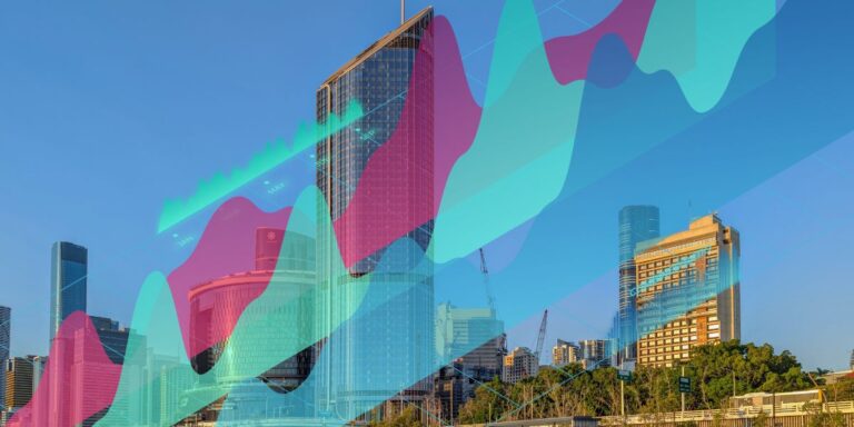 City skyline with glass skyscrapers overlaid by colorful translucent data-visualization waves, conveying analytics in an urban setting