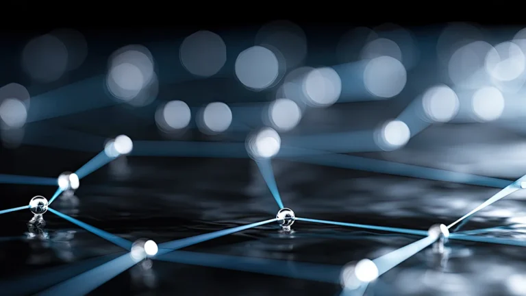 Abstract blue network: glowing nodes connected by thin lines on a dark surface, representing a digital interconnected system.