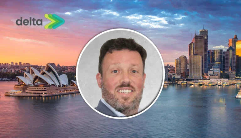 Delta logo in the top-left; Sydney Opera House and skyline at sunset behind a centered circular portrait of a smiling man in a suit.