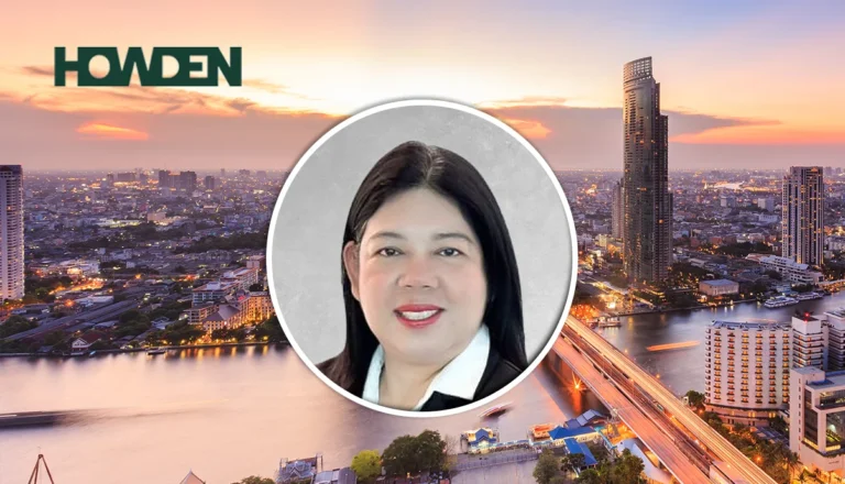 Circular portrait of a smiling woman over a sunset cityscape with a Howden logo in the corner