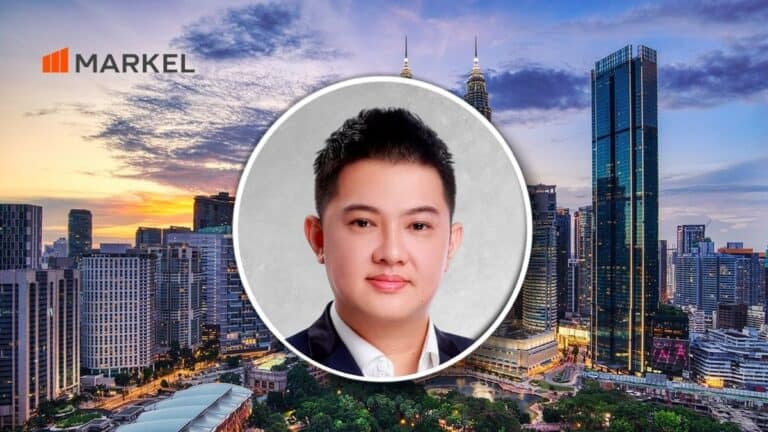Portrait of a man in a suit centered over a city skyline at sunset, with the MARKEL logo in the upper left.