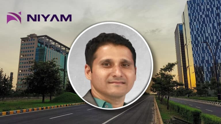 Circular headshot of a smiling man over a city street backdrop with the NIYAM logo in the top-left corner.