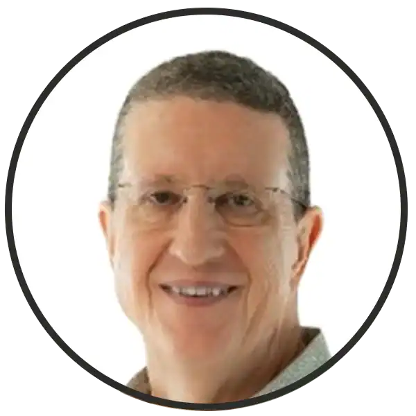 Smiling head-and-shoulders portrait of a man with short gray hair and glasses (circular image).