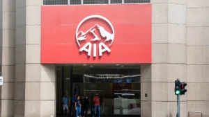 AIA office entrance with a red sign displaying the white AIA logo above glass doors and pedestrians entering