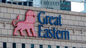 Red lion logo in pink with blue “Great Eastern” text on a beige brick wall of a building sign (corporate logo)