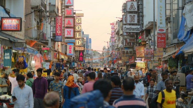 Bustling street scene in India with shops and crowds, related to Indian Bank's financial services.