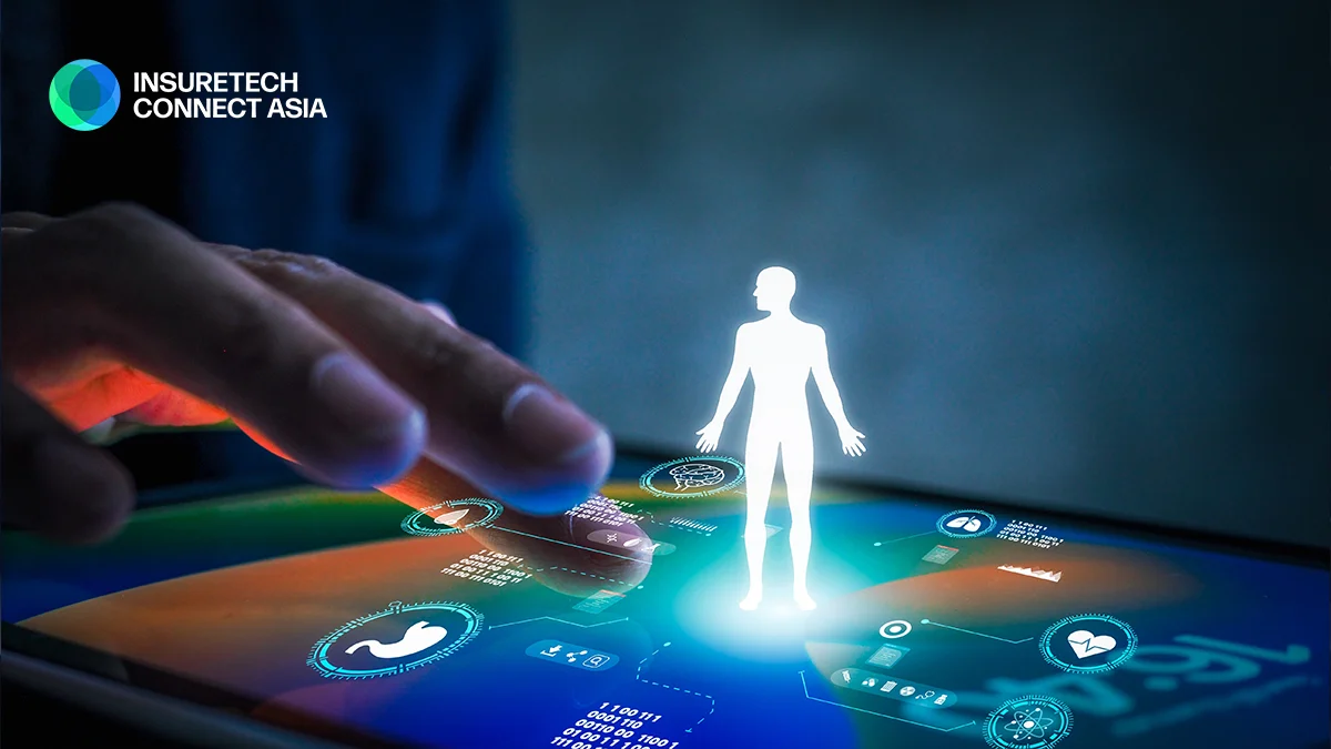 Glowing white human silhouette hovering above a futuristic touchscreen with holographic UI, InsureTech Connect Asia logo in the corner.
