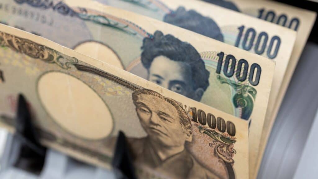 Fanned Japanese yen banknotes, showing 1,000 and 10,000 yen bills, close-up view of the currency stack