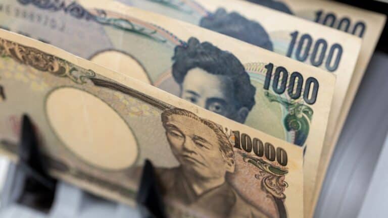 Fanned Japanese yen banknotes, showing 1,000 and 10,000 yen bills, close-up view of the currency stack
