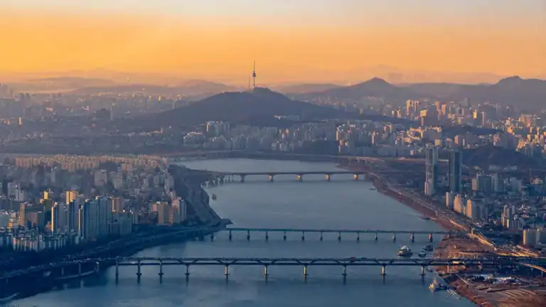 Seoul cityscape with Han River and Namsan Tower, South Korea, at sunset.